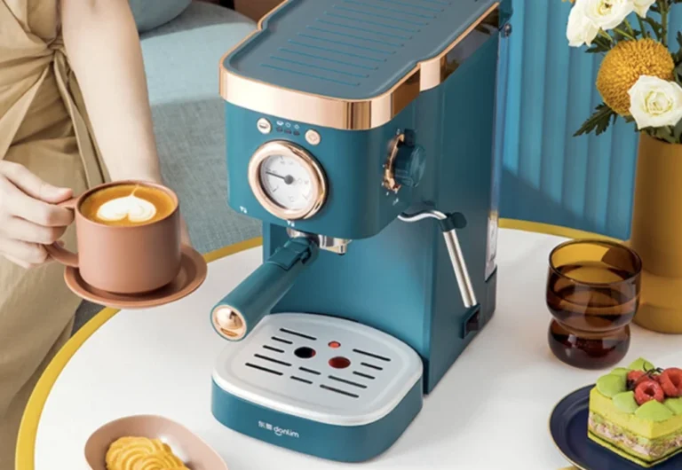 Person using stylish blue espresso machine.