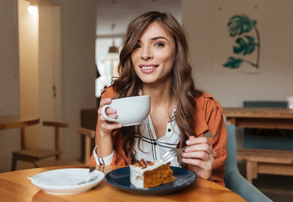 Woman enjoying coffee and cake in cozy cafe.