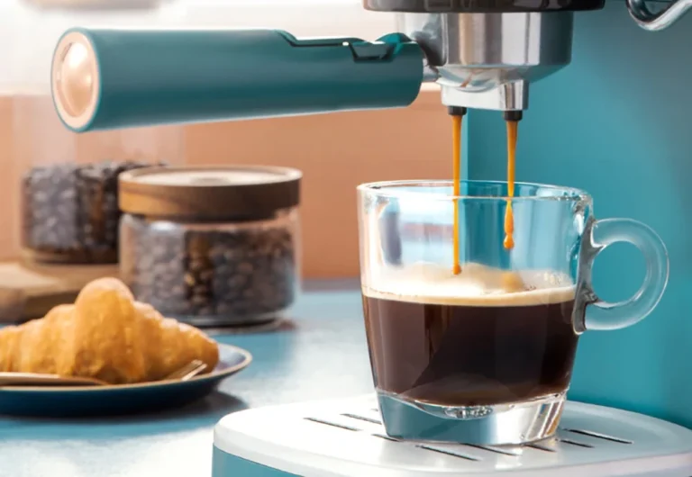 Espresso machine pouring coffee into glass mug.