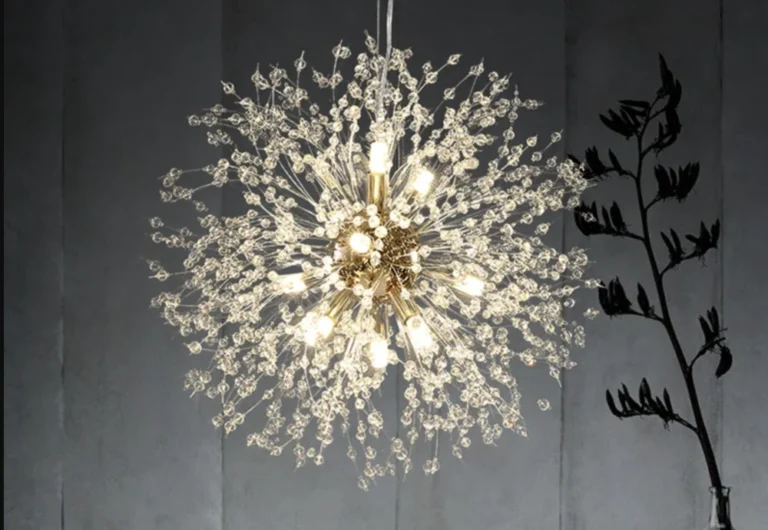 Elegant crystal chandelier with branching design against dark backdrop.