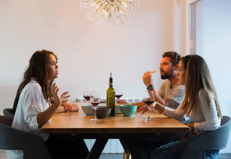 Four friends enjoying dinner and conversation.