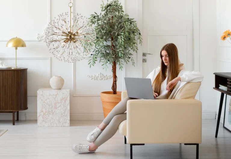 Woman working on laptop in stylish living room.