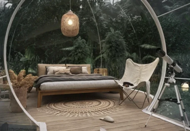 Glass dome bedroom with nature view and telescope.