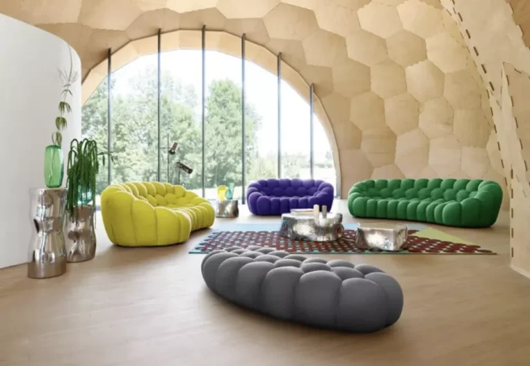 Colorful modern sofas in stylish arched room with large windows.