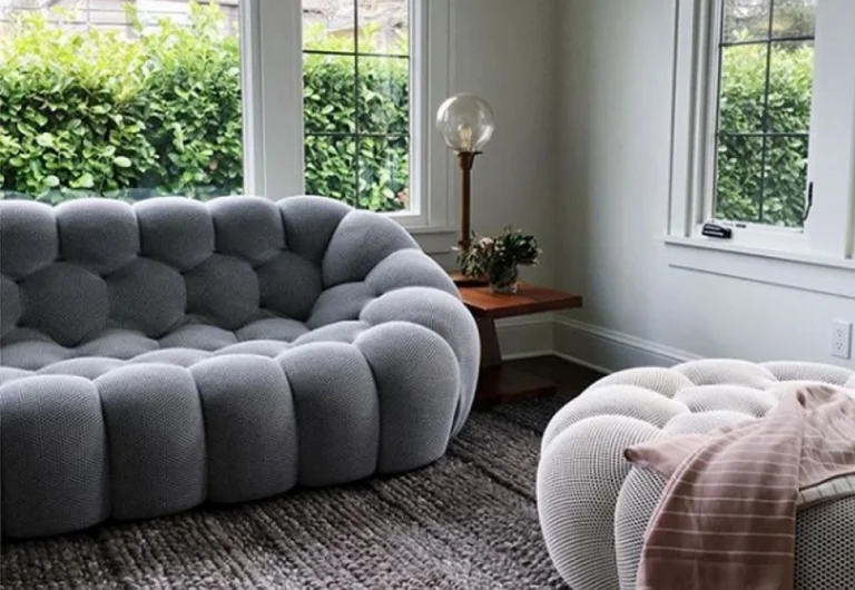 Cozy living room with stylish tufted sofas and natural light.