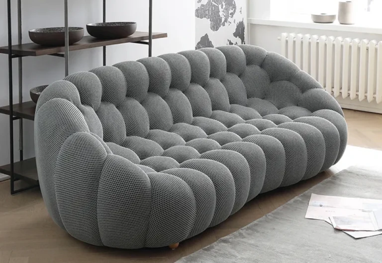 Modern gray tufted modular sofa in minimalist living room.