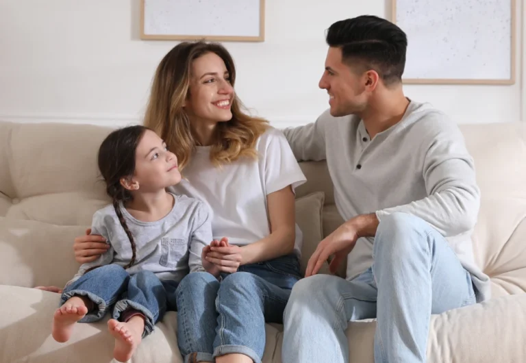 Family relaxing together on living room sofa.