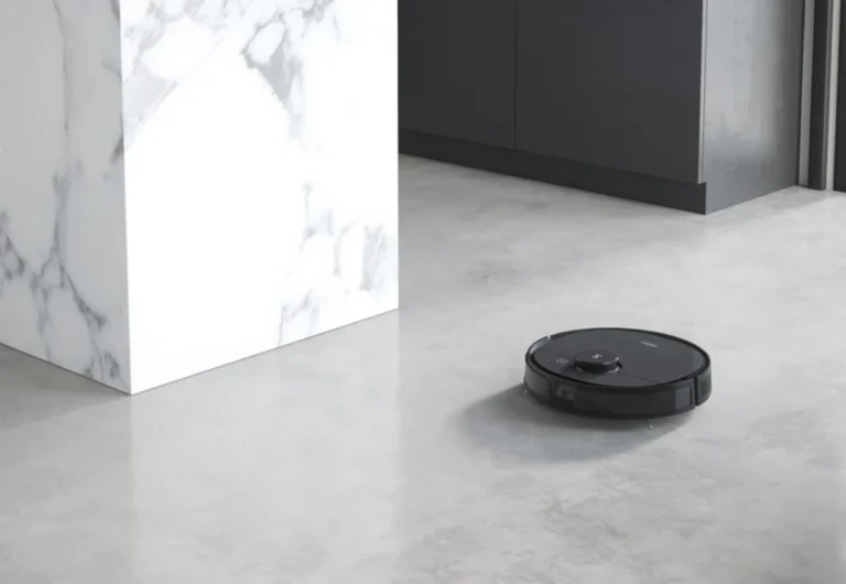 Robotic vacuum cleaner operating in modern kitchen.