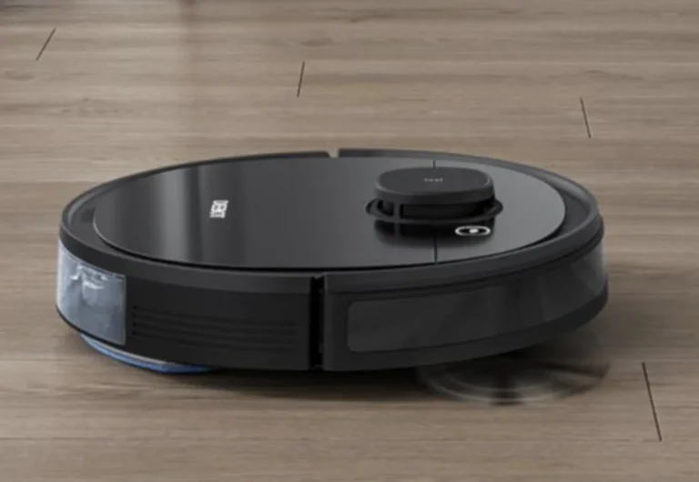 Robotic vacuum cleaner operating on wooden floor.