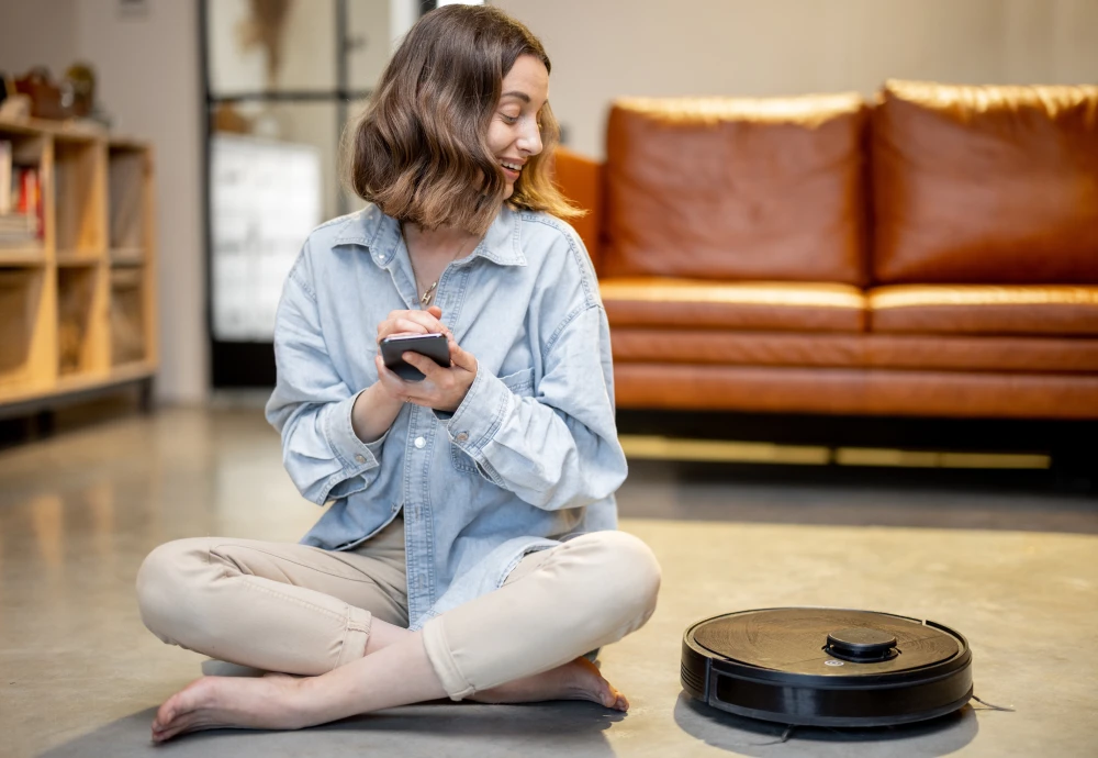 Woman using smartphone near robotic vacuum cleaner indoors.