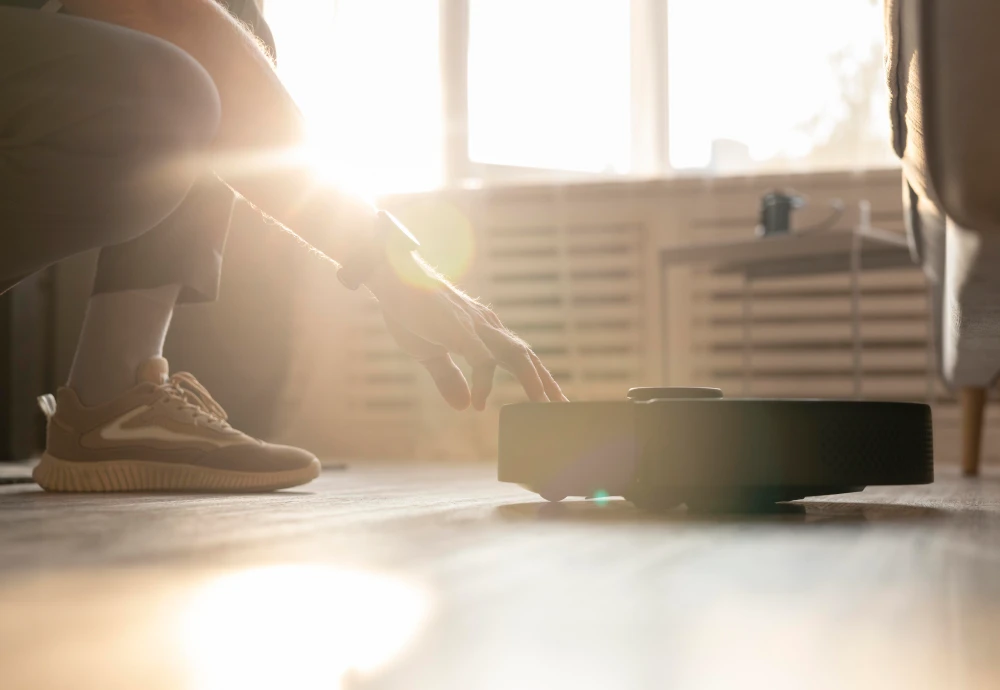 Person activating robotic vacuum cleaner at home.