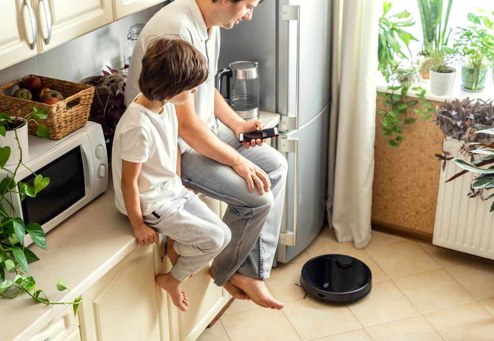 Father and son watching robot vacuum clean kitchen.