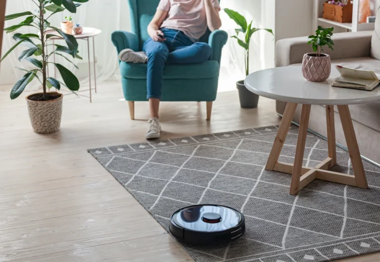 Person relaxing, robot vacuum cleaning modern living room.