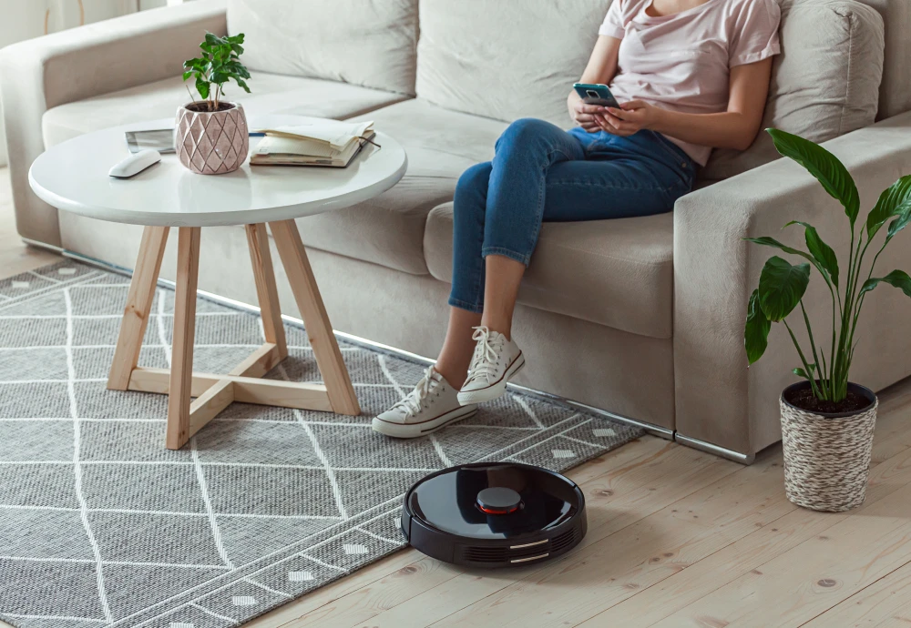 Woman using smartphone with robot vacuum cleaning floor.